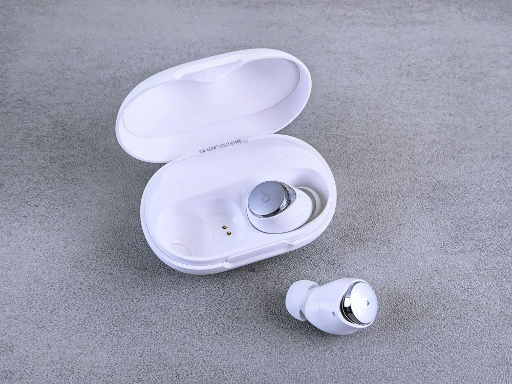 White earbuds with open charging case