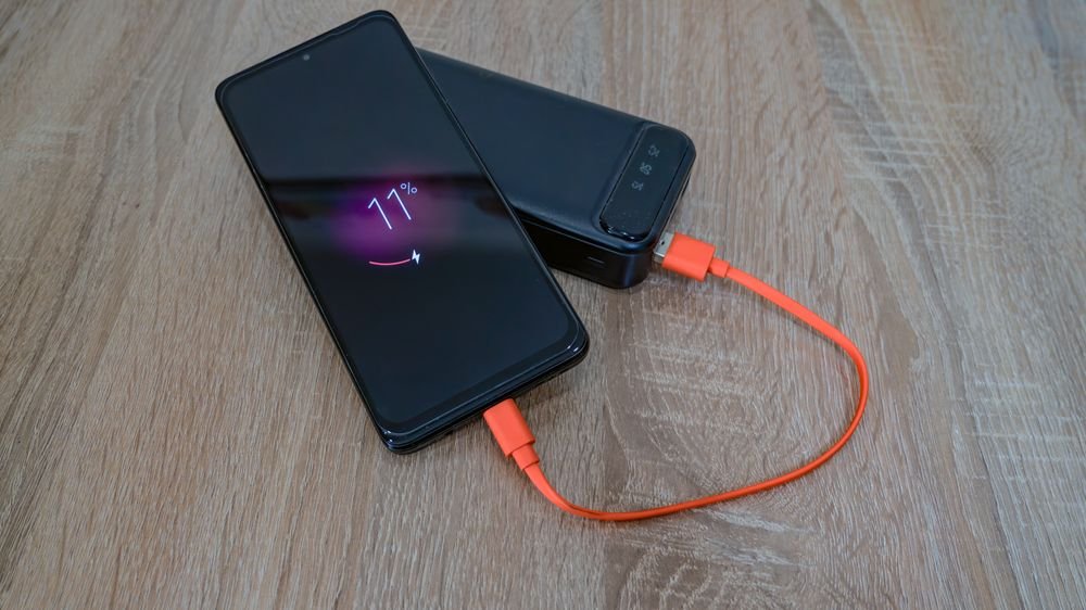 Phone charging from power bank with orange cable